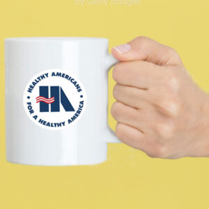 Caucasian female is holding a white coffee mug in hand in front of a yellow background.